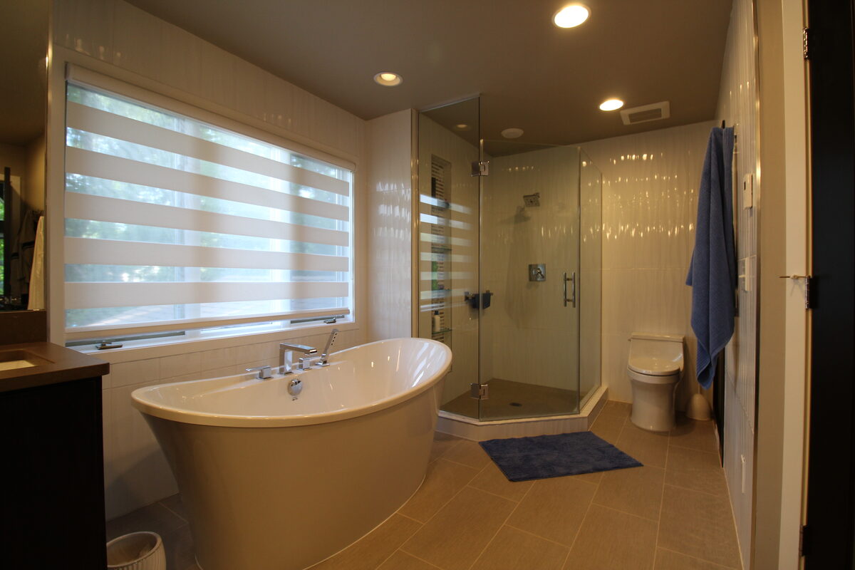 Spa-style bathroom with freestanding tub and glass shower
