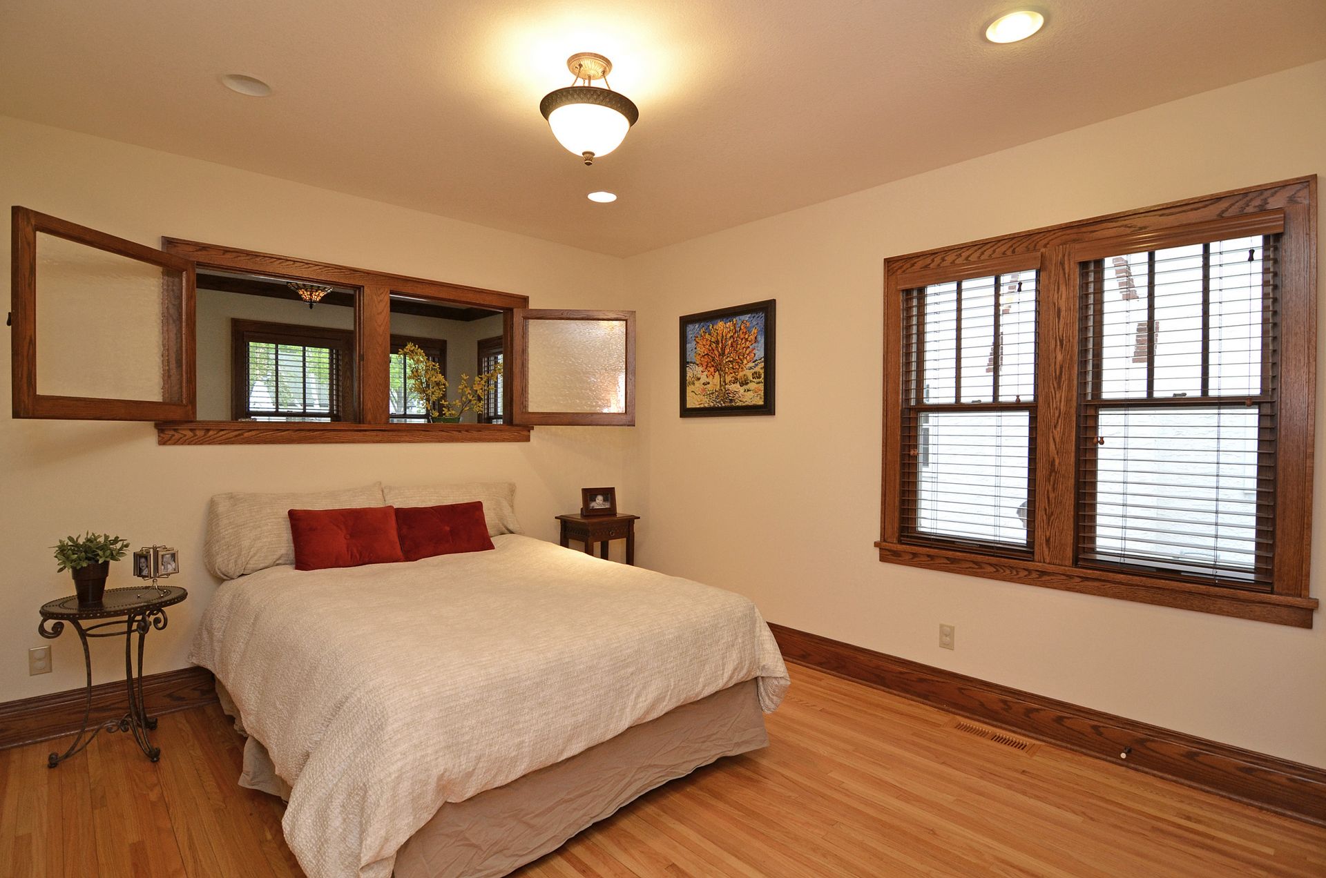 Bedroom with restored trim and hardwood floors.