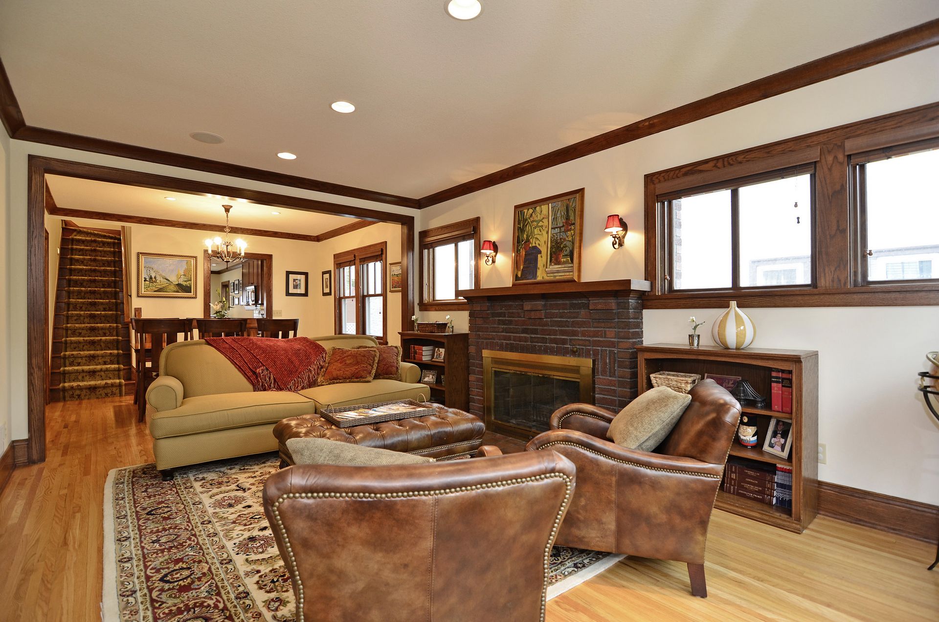 Living room with brick fireplace and oak trim.
