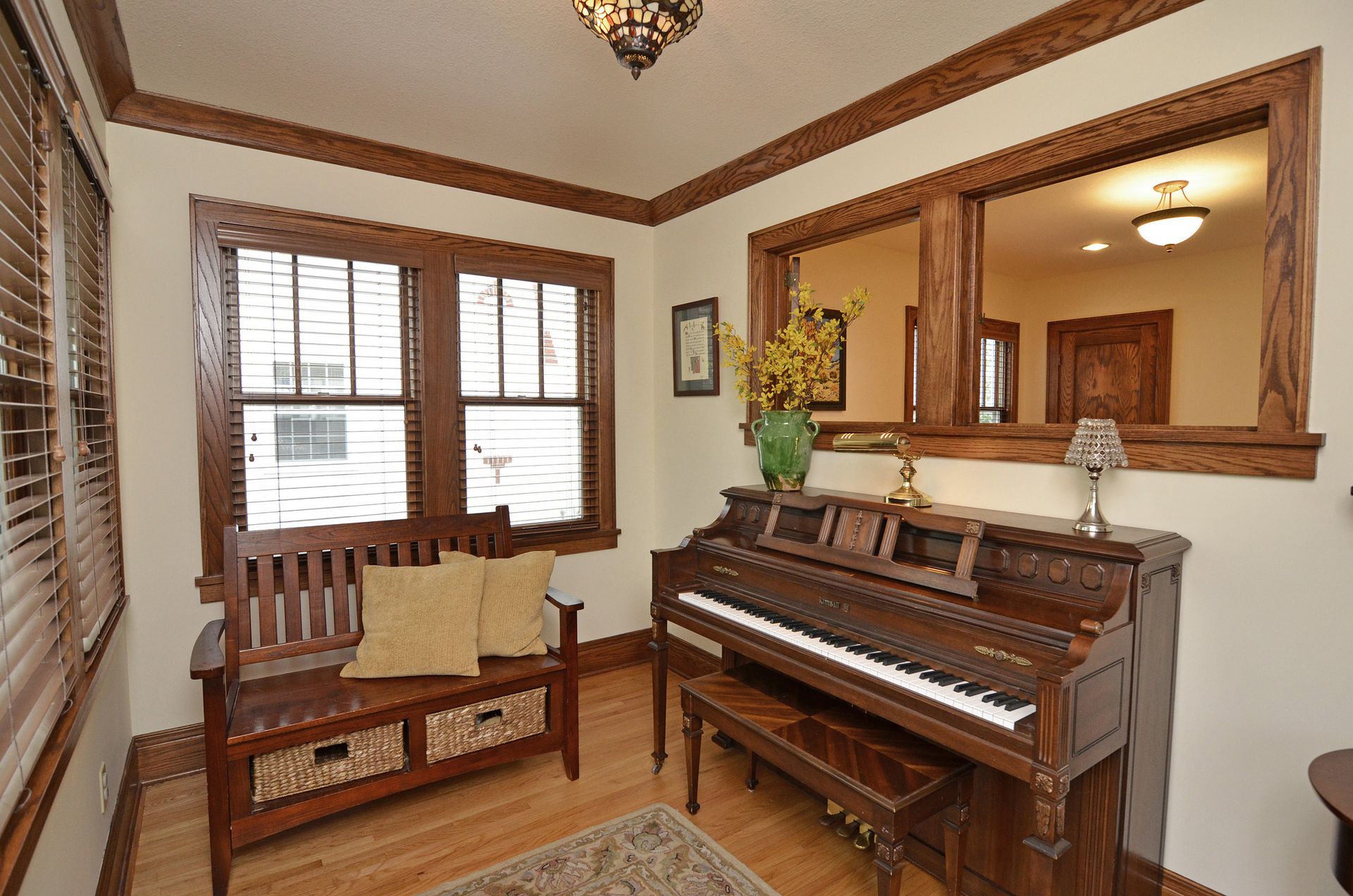 Music nook with piano and oak trim.