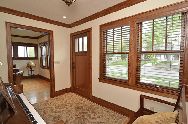 Entry and front room with restored oak trim.