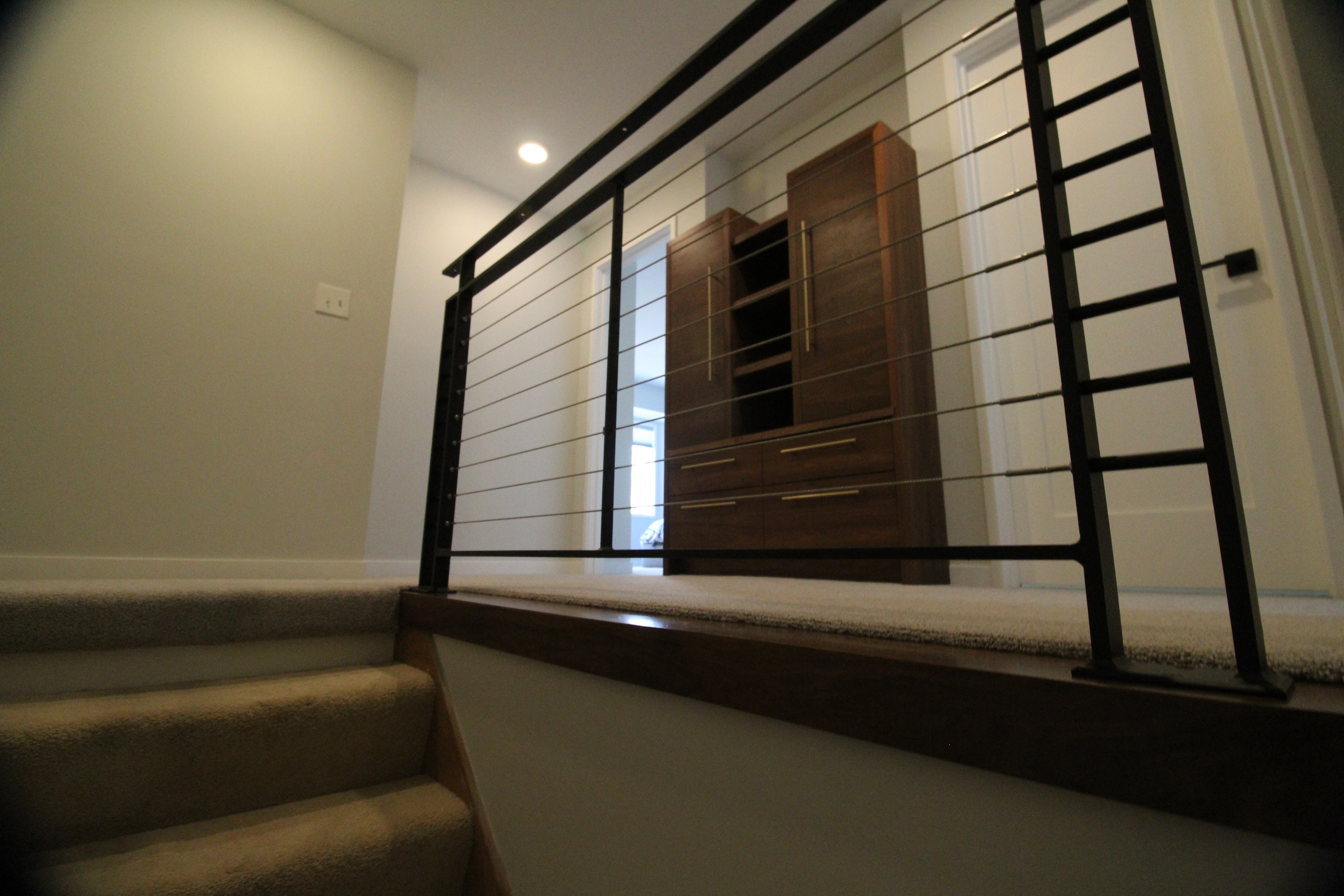 Stair landing with modern cable railing and clean trim details.