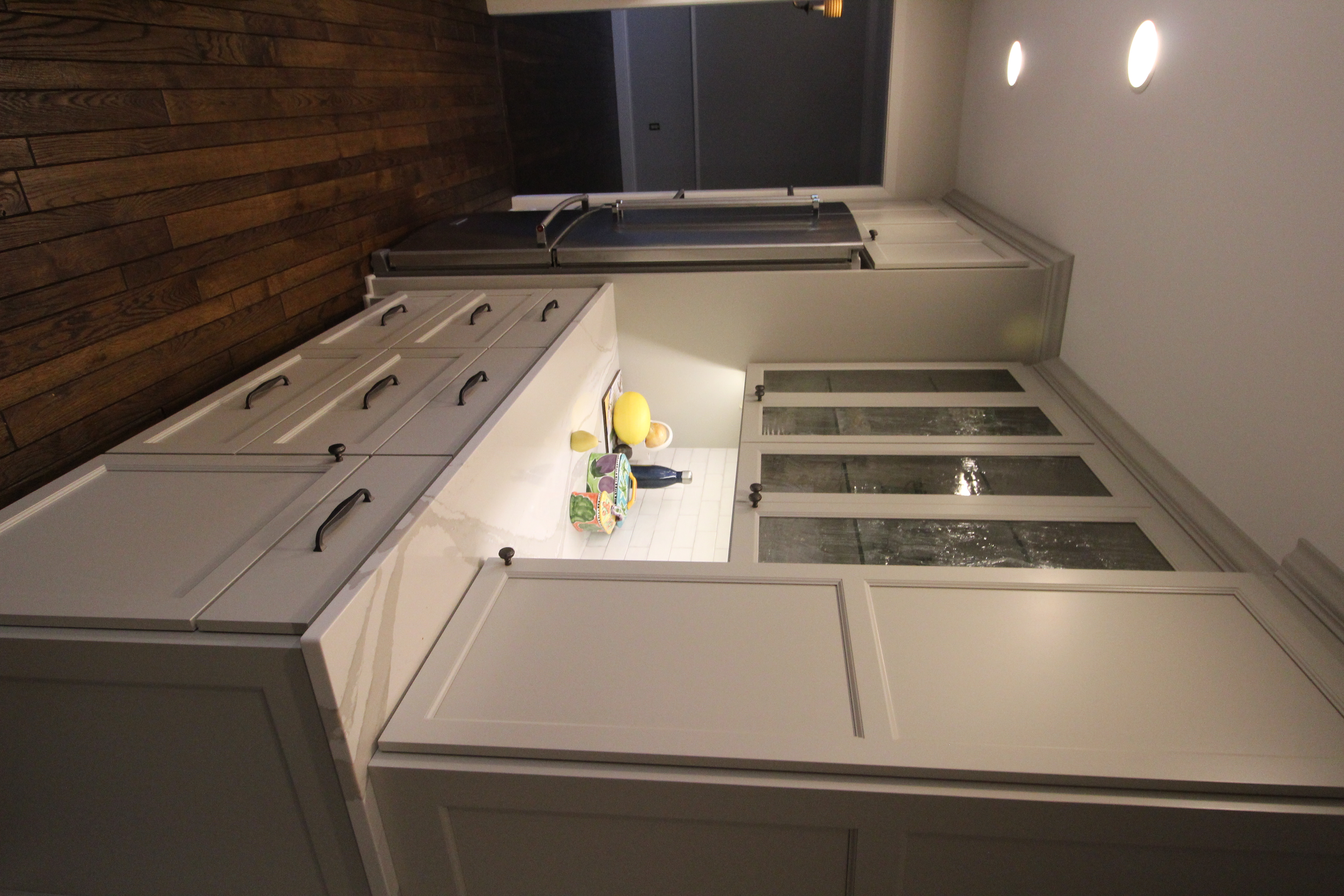 Open kitchen perspective showing the quartz island seating, classic subway tile backsplash, and generous circulation for entertaining.