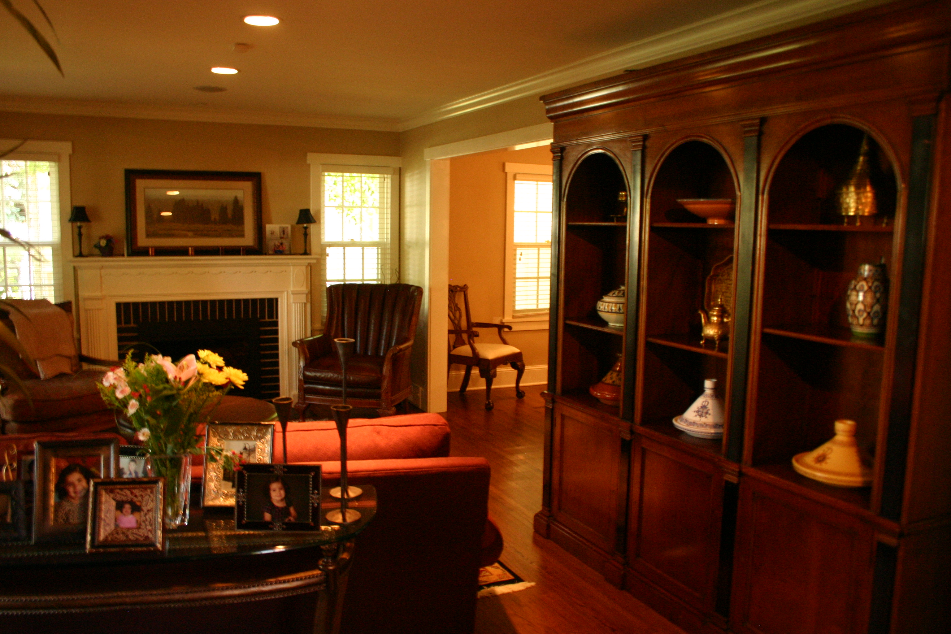 Dining area connected to screened porch with chandelier lighting.