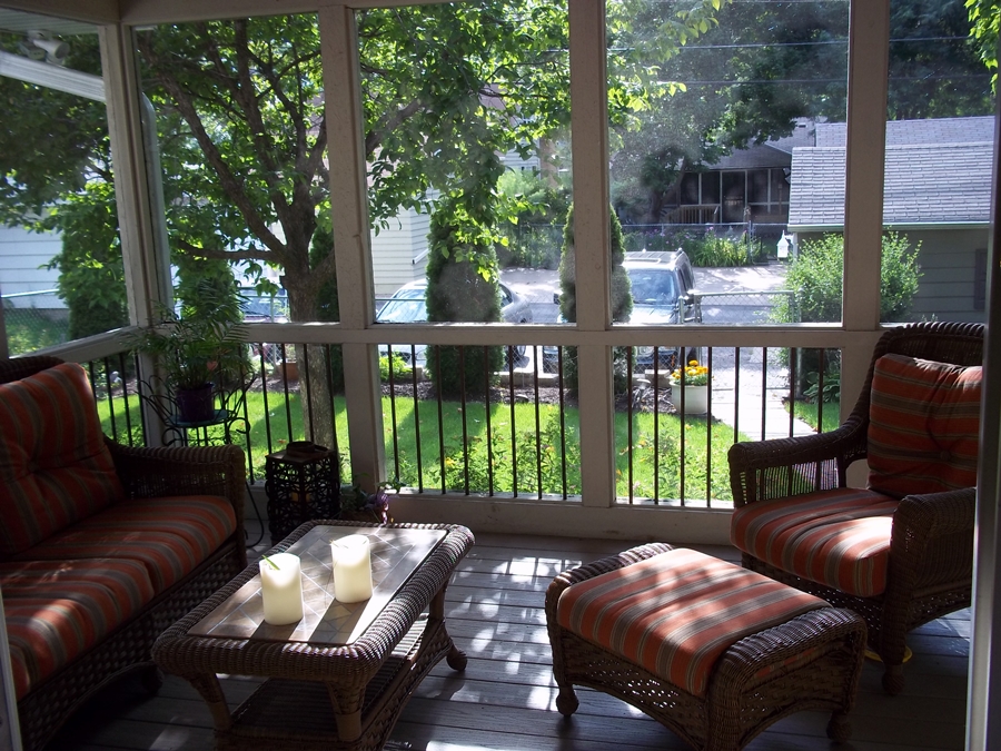 Screened porch view with lounge seating.