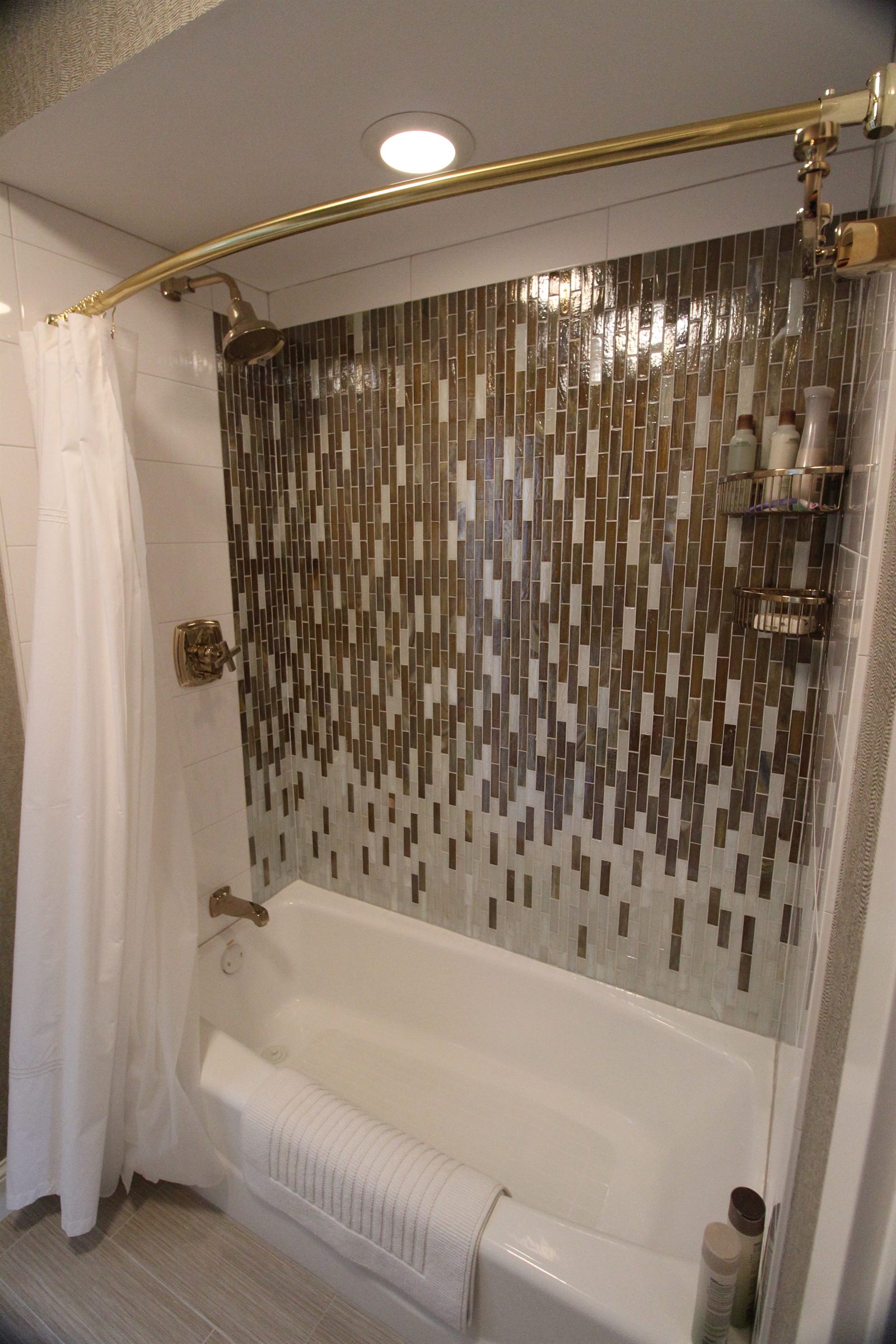 Refined bathroom with custom tile, glass enclosure, and durable waterproofing system