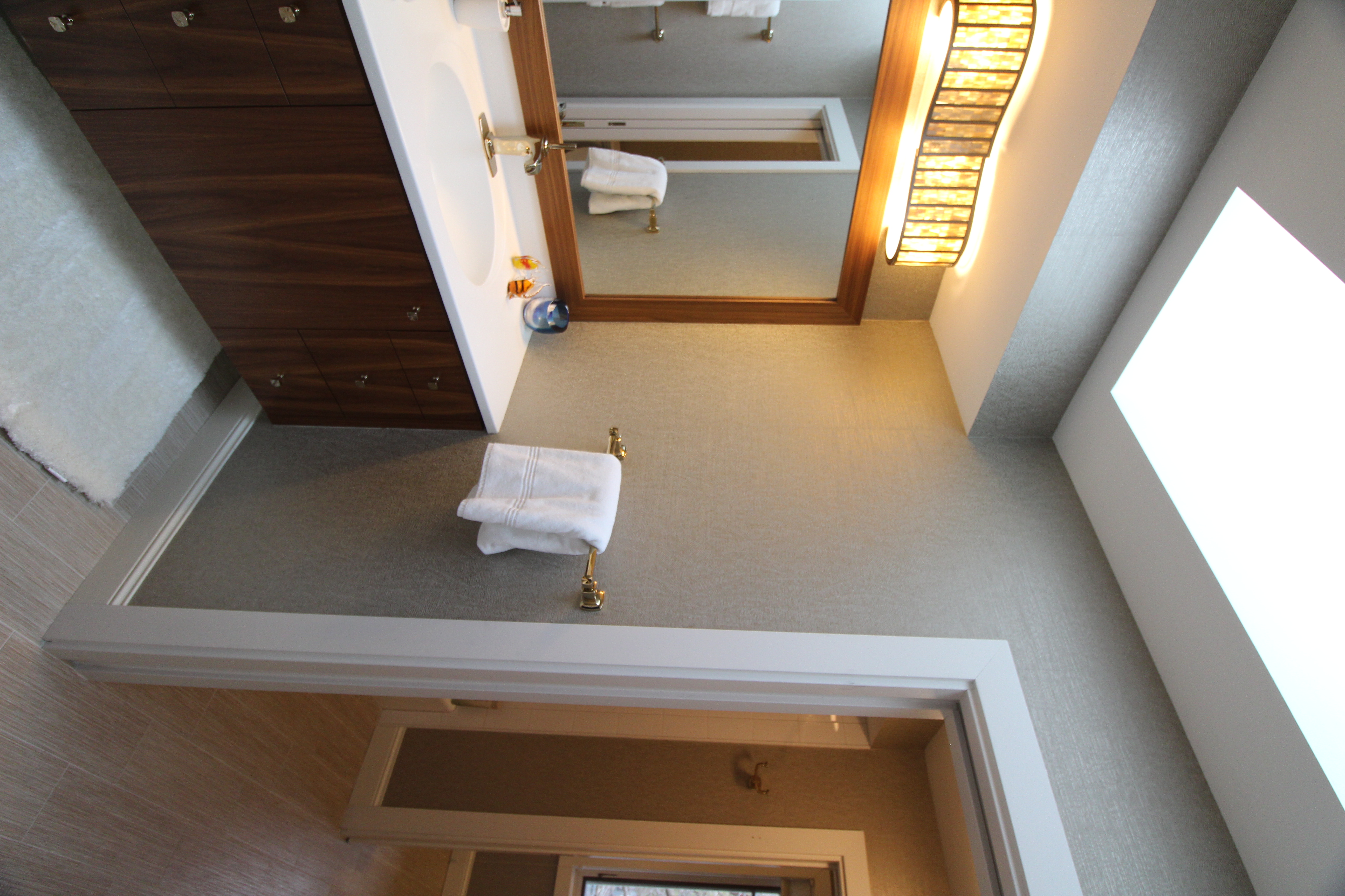 Frameless glass shower with clean tile detailing and minimalist hardware