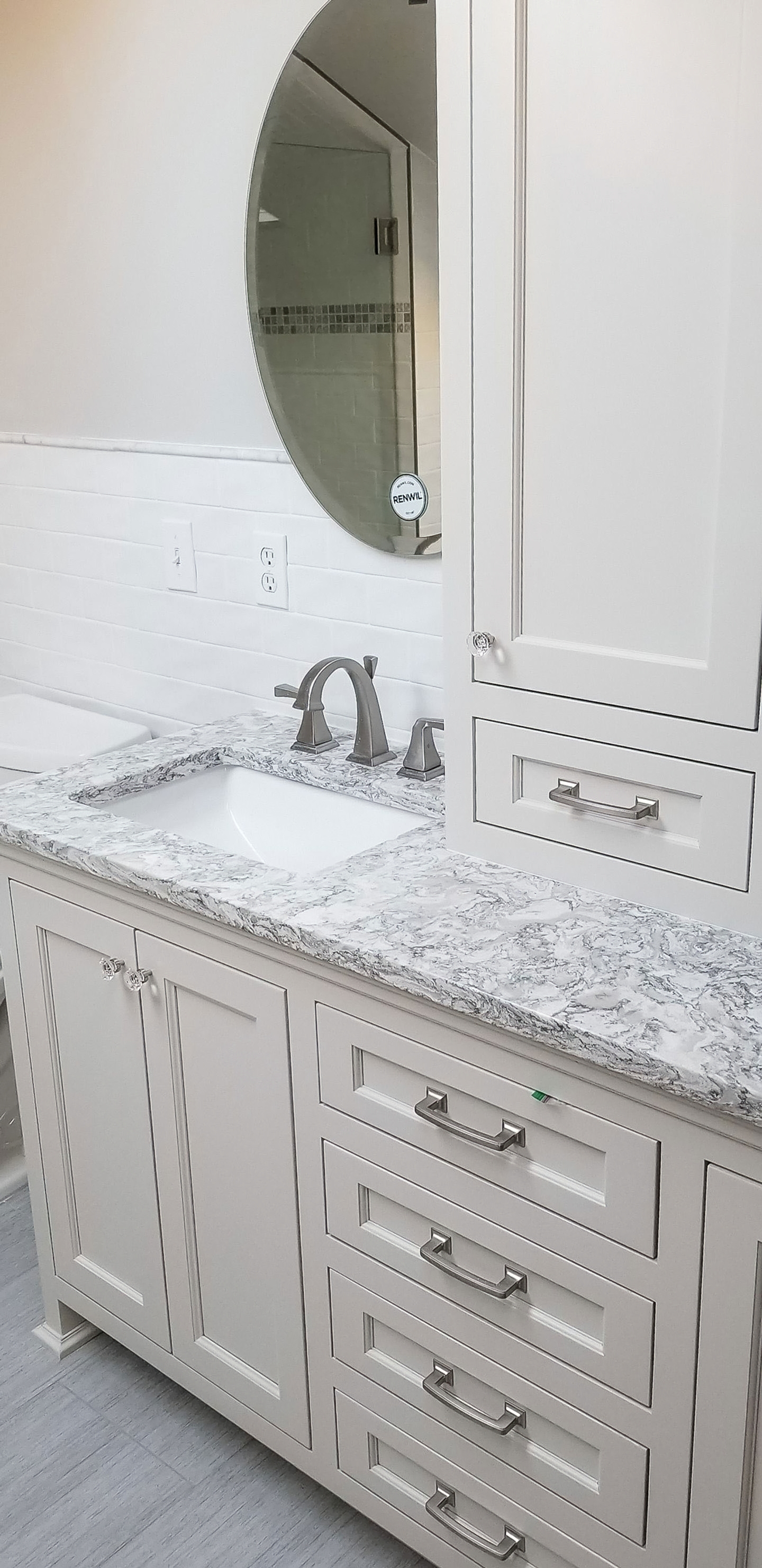 Wide view of a completed bathroom remodel with tub, shower, and custom cabinetry
