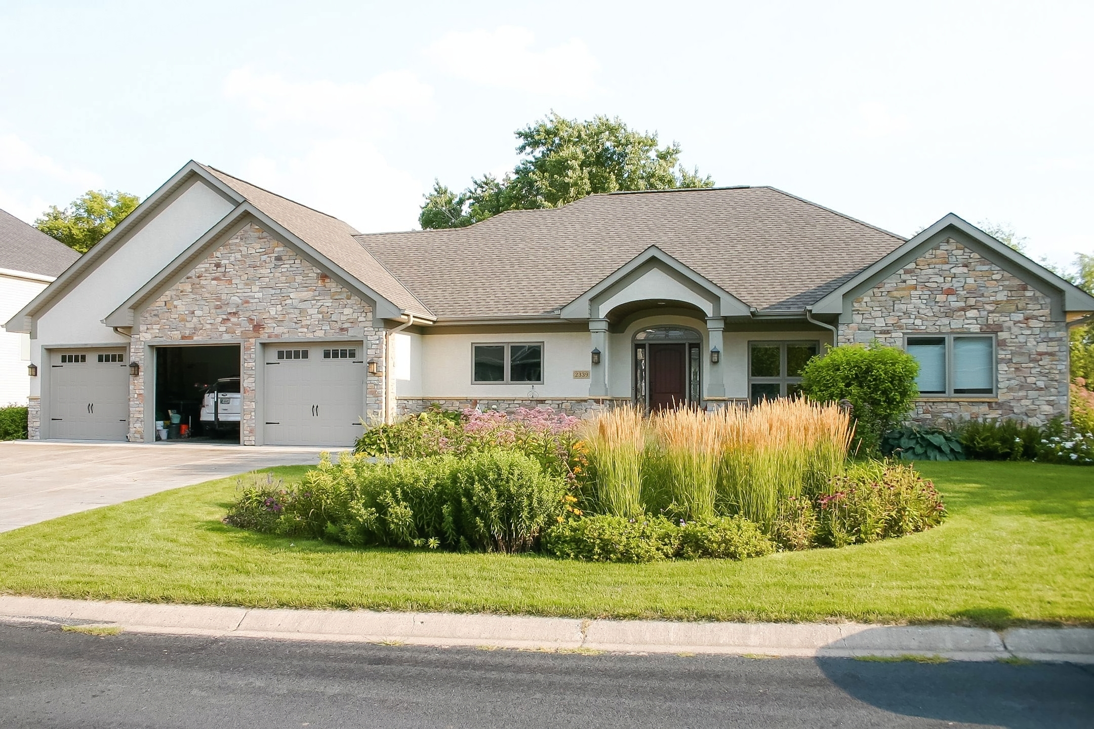 Bathroom layout showing tall storage cabinet, vanity, and glass shower with clean tile detailing.