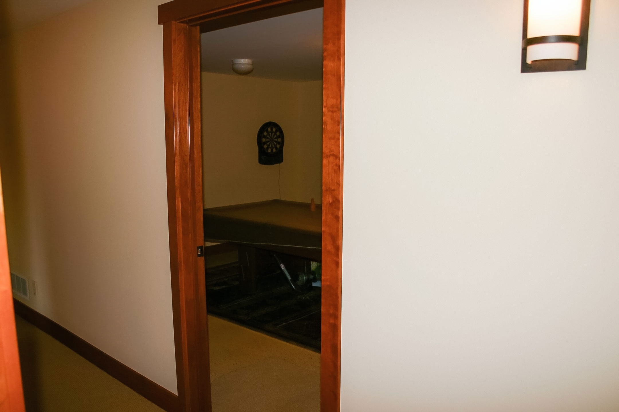 Living area perspective highlighting warm woodwork, built-ins, and a comfortable seating zone.