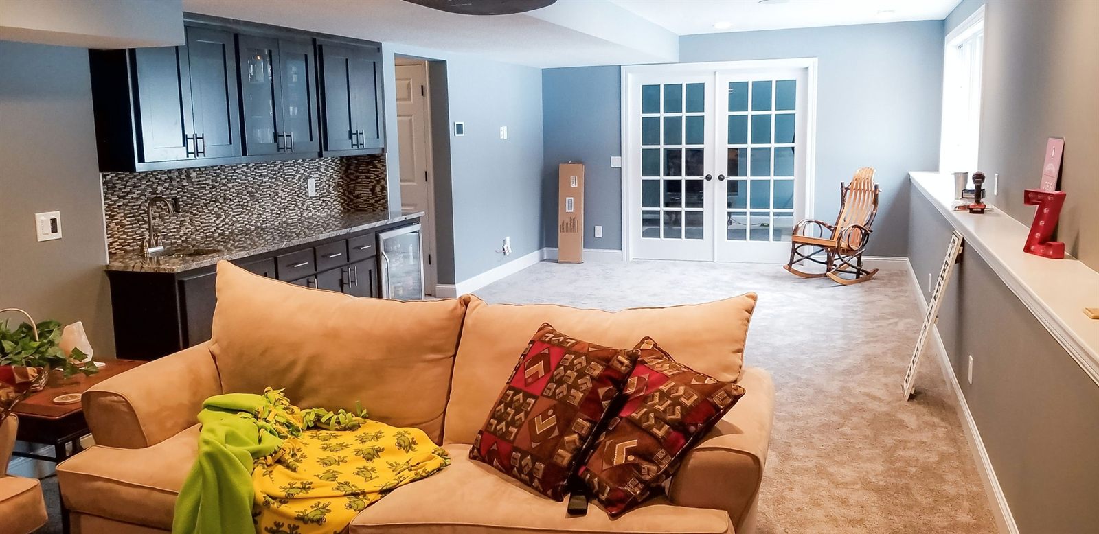 Finished lower level designed for daily family use with durable material selections